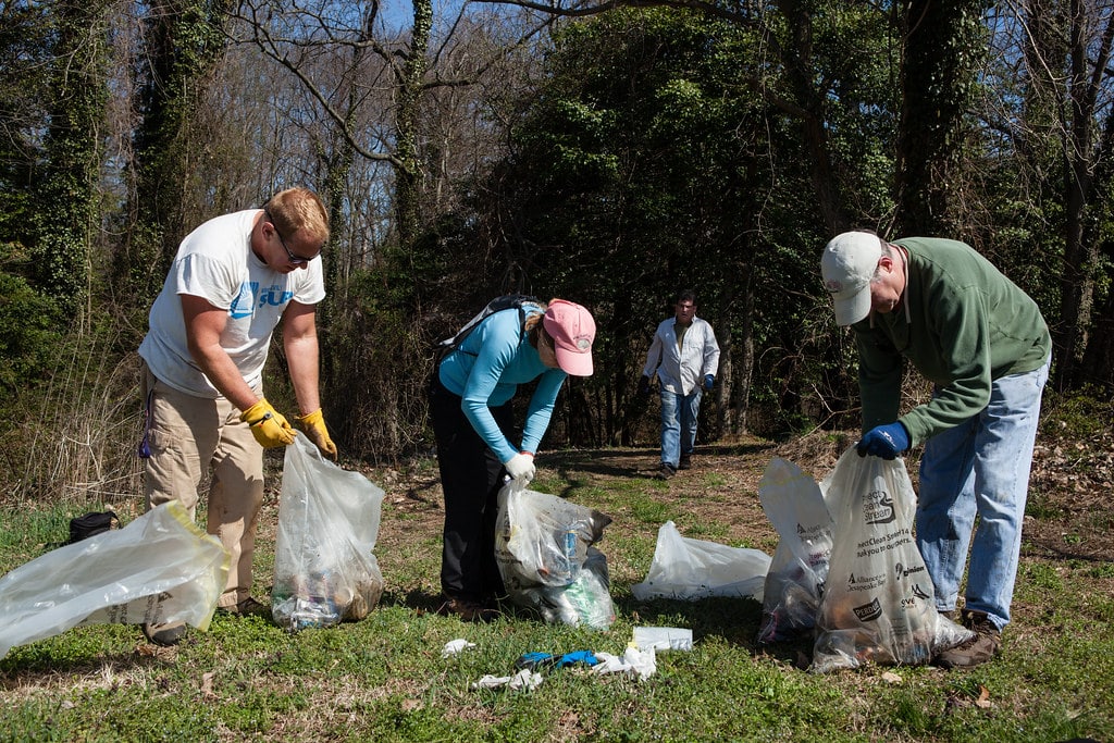 Group of multimedia design students volunteering for environmental causes, working on a project to support the Global Plastics Treaty and promote sustainability.